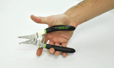 Pro Stainless Wire Stripper Cutter And Crimper Curve tool held in hand, showcasing stainless steel design and ergonomic grip.