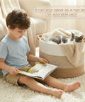 Child sitting next to 70L Cotton Rope Basket For Living Room And Nursery, Boho Woven Toy Box, Kid Safe, with cat resting inside