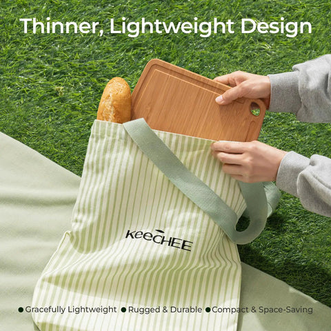 Person placing Dishwasher Safe Carbonized Bamboo Cutting Board With Juice Groove For Fruit Veggies And Cheese into a tote bag