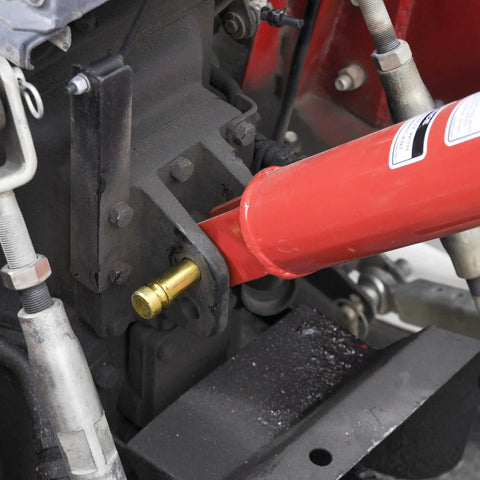 Close-up of red PTO driveline connected to gearbox on 3 Point Post Hole Digger For Tractors With 6 Inch Auger Fits Compact And Sub Compact Cat 0 Tractors Beefy Right Angle Gearbox PTO Driveline Safety Shields A Frame Lift Arm 21 Inch Spacing Hardware Kit Included.