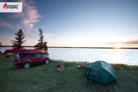 Camping scene with SUV and tent by lake, showcasing Beefy Outdoor Bungee Cord Set With 12 Heavy Duty Cords 72 Inch Long Double J Hooks.