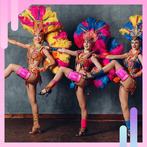 Dancers wearing the holographic thigh bag with adjustable strap leg pouch harness for women, showcasing pink leg bags at a festival.