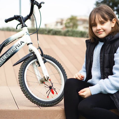 Young girl sitting next to bike with Totally Sick Spider Bike Wheel Spoke Lights LED Glow For Night Rides attached; child-friendly accessory.