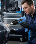 Man using Heat Gun With Dual Temperature 572 To 1112 Fahrenheit, Two Speed, 110 Volt, for auto repair, blue tool in focus.
