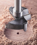 Close-up of Rock Hard Tungsten Carbide Forstner Drill Bit 10Mm cutting through wood, showing precision tool detail and clean hole.