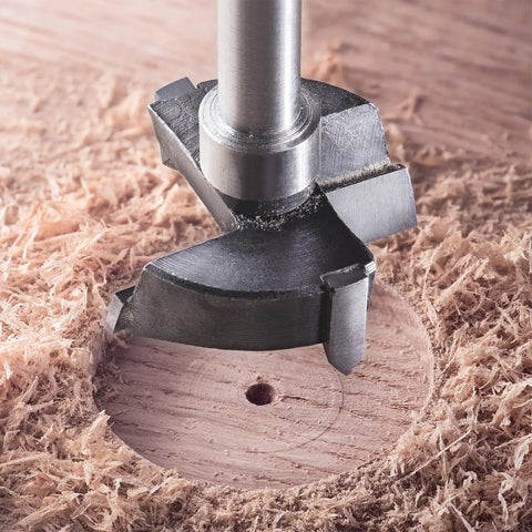 Close-up of Rock Hard Tungsten Carbide Forstner Drill Bit 10Mm cutting through wood, showing precision tool detail and clean hole.