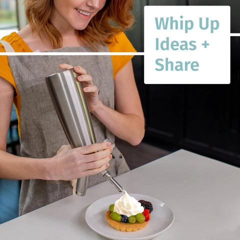 Person using 304 Stainless Steel Whipped Cream Dispenser 500ml With 3 Decorating Nozzles on dessert in kitchen.