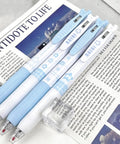 Four Pack Cute Retractable Gel Pens Blue Star 0.5mm Fine Point Black Ink with star patterns on open magazine