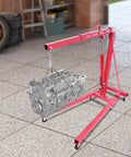 Tough as Nails Hydraulic Engine Hoist 1 Ton Cherry Picker lifting an engine in a garage, showcasing rust-resistant carbon steel frame.