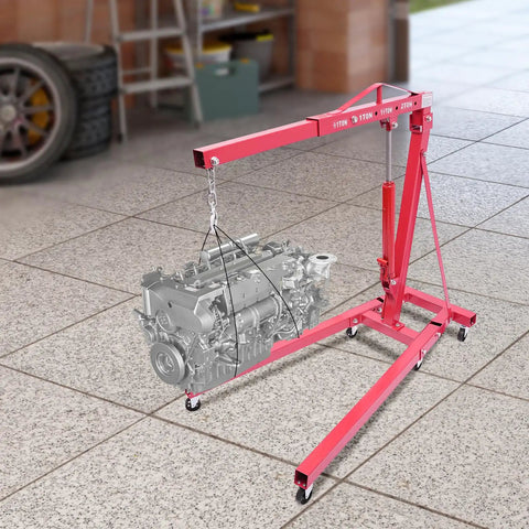 Tough as Nails Hydraulic Engine Hoist 1 Ton Cherry Picker lifting an engine in a garage, showcasing rust-resistant carbon steel frame.
