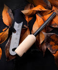 4 Pack Five Sixteenth Inch Ferro Rod Fire Starters with wood handle and multi-tool striker on autumn leaves