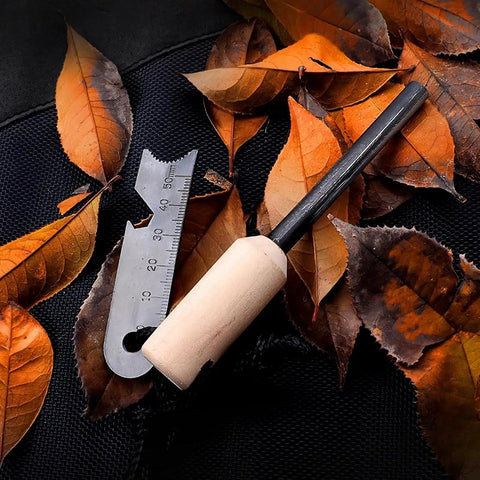 4 Pack Five Sixteenth Inch Ferro Rod Fire Starters with wood handle and multi-tool striker on autumn leaves