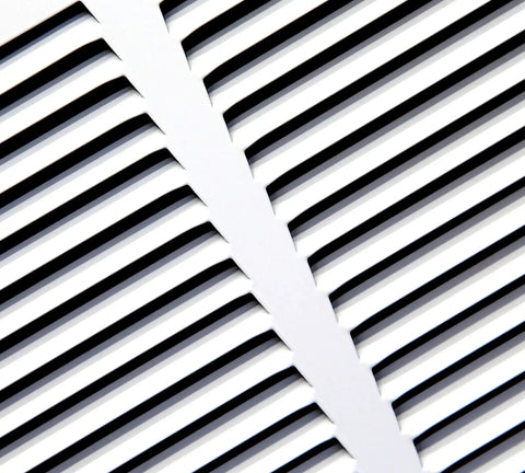 Close-up view of white Baseboard Return Air Grille for 30x6 Duct Opening with seven eighths inch margin turnback, powder coated finish.