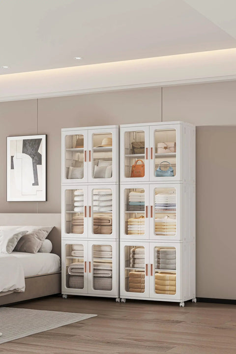 Three Tier Foldable Storage Cabinet On Wheels With Lids And Doors, Plastic Stackable Pantry Cupboard Closet Organizer in a bedroom