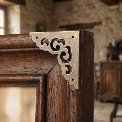 Metal Corner Protectors Set 12 Ornate Edge Guards Made Of Zinc Alloy Old School Vintage Look For Frames And Wooden Tables Easy Install Prevents Chipping Classic European Retro Style Hardware on a wooden frame corner.