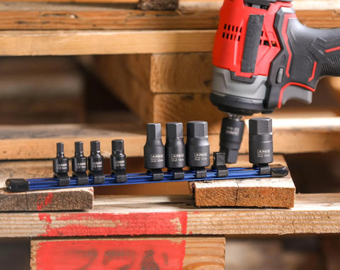 Nine Piece Metric Impact Hex Driver Set With Chrome Moly Steel And Manganese Phosphate Coating Includes One Quarter Inch Drive Sockets In 6mm 7mm 8mm 10mm And Three Eighth Inch Drive Sockets In 12mm 14mm 17mm 18mm 19mm Low Profile Design With Storage next to impact driver on wooden surface