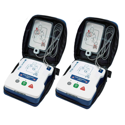 Two AED UltraTrainers from the Take2 CPR Manikin And UltraTrainer Kit With Feedback For Realistic Practice Two Adults And Two Infants Plus Two AED UltraTrainers And Full Accessory Pack Including Shields Lung Bags Kneeling Mats ManiVests ManiBibs And Carry Bags, shown in open position with attached cables.