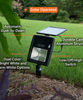 Outdoor Solar Flood Light in Black Cast Aluminum with Warm White 2700K LEDs, ground stake, solar panel, lush garden setting