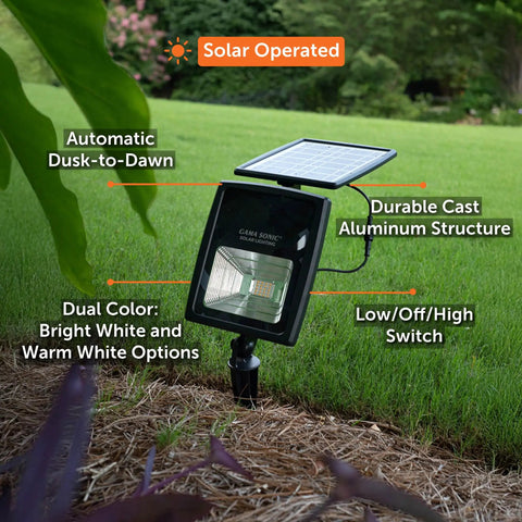 Outdoor Solar Flood Light in Black Cast Aluminum with Warm White 2700K LEDs, ground stake, solar panel, lush garden setting