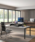 Standing Desk Converter 48 Inch Wide Sit Stand Desk Riser with dual monitors in modern office setting, black finish.