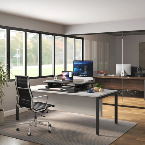 Standing Desk Converter 48 Inch Wide Sit Stand Desk Riser with dual monitors in modern office setting, black finish.