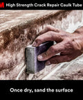 Hand sanding a crack filled with Heavy Duty Crack Repair For Walls And Ceilings, 7 Oz Squeeze Tube With Precision Tip
