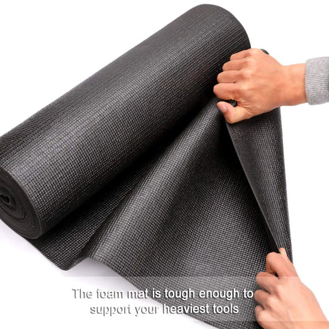 Hands holding the Non Slip Foam Rubber Toolbox Drawer Liner 18 Inch By 24 Feet Easy Cut Mat with grid lines for scratch protection.