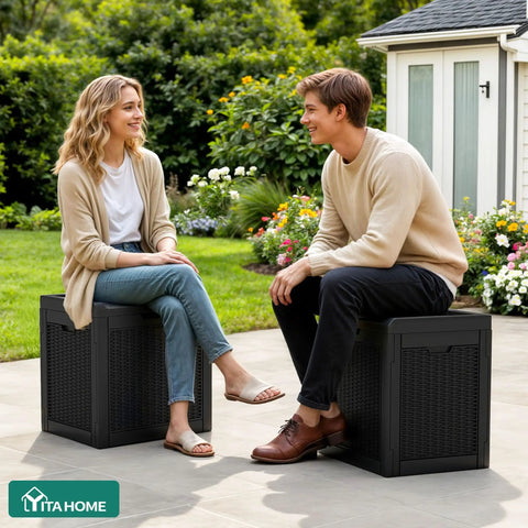 Two people sitting on 32 Gallon Resin Deck Box With Lockable Lid And Easy Carry Side Handles For Indoor Outdoor Storage