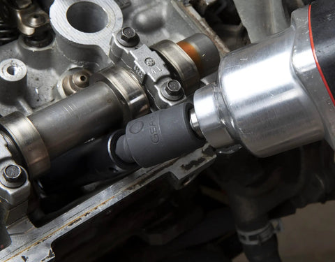Impact Universal Joint Set, Three Piece For One Quarter Inch, Three Eighth Inch, And One Half Inch Drive, Reaches Tight Angles With Easy Access, Works With Air, Electric Or Battery Tools, Manganese Phosphate Finish, Meets ASME Specs, Model 84969A-07, shown in use with pneumatic tool, reaching engine bolts.