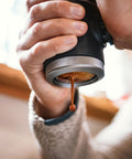 Picopresso Portable Espresso Maker Bundle in use, showcasing manual extraction of espresso for creamy shots.