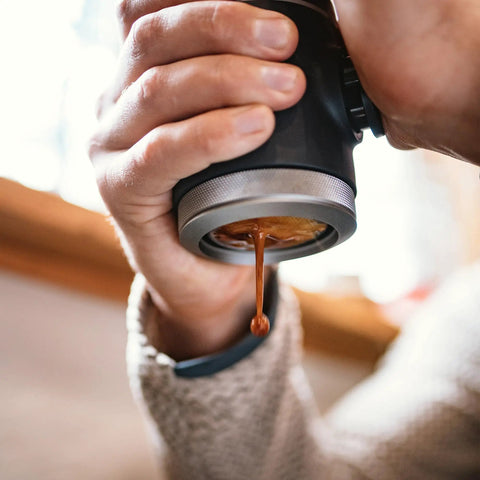 Picopresso Portable Espresso Maker Bundle in use, showcasing manual extraction of espresso for creamy shots.