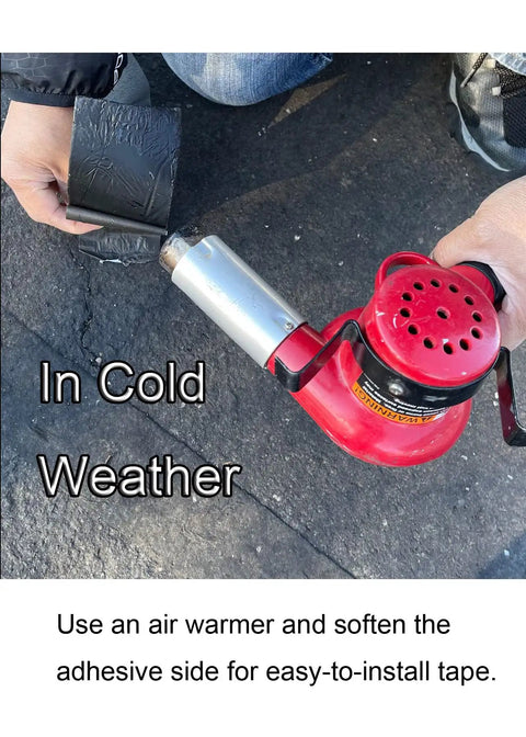 Person using a heat gun on 65 Ft By 3 In Self Adhesive Bitumen Patch Tape For Asphalt Crack Sealing And All Weather Repairs Heavy Duty Tarmac Joint Tape For Parking Lots Roofs Driveways And Leaks On Rubber Or Vinyl Surfaces in cold weather
