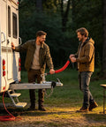 Two people attaching Breakaway Cable For RV Trailers 4 Foot Or 6 Foot High Strength Flexible Towing Lanyard with 4mm wire to an RV.