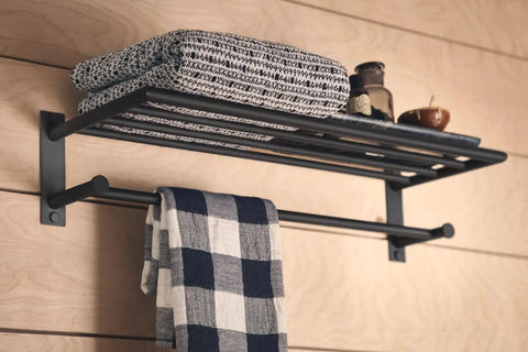 24 Inch Wide Matte Black Towel Storage Shelf with Towel Bar Modern Hotel Style Bathroom Organizer with towels displayed