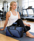 Person sitting in gym with Two Pack 20L Underseat Carry On Bag For Airlines Flight Friendly Duffle With Multiple Pockets Adjustable Shoulder Strap