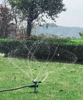360 Degree Rotating Lawn Sprinkler For Large Area Coverage With Adjustable Spray Directions Direct Or 45 Degrees, Weighted ABS Plastic Three Arm Watering System Delivers Even Hydration And Hassle Free Setup For Your Yard spraying water on grass