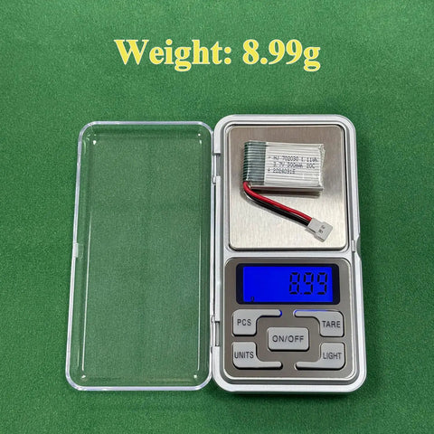 2 Pack 3.7V LiPo Battery 300mAh Rechargeable for RC Planes Helis Drones and All Toys with XH254 Connector Compact 33x20x6mm USB Charging Cable Included on a scale showing 8.99g weight