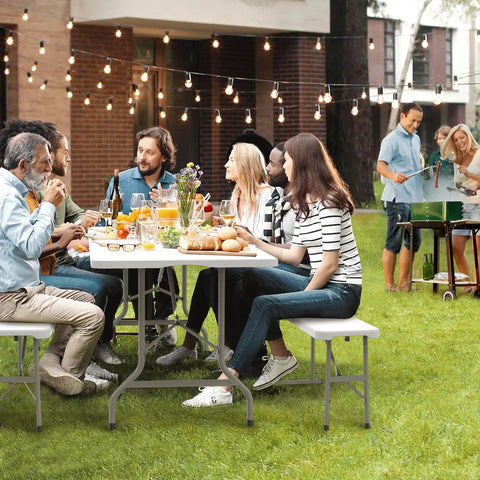 Six Foot Picnic Table Set With Two Benches, Three Piece Folding Outdoor Table And Chair Set For Indoor Or Outdoor Use, Smooth White Tabletop, Sturdy HDPE Waterproof Build, Non-Slip Surface, Grab-and-Go Camping Gear in a garden gathering