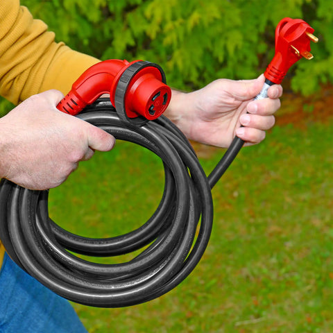 Person holding RV Power Cord 30 Amp 25 Foot with 90 Degree Detachable Plug Red Beefy Heavy Duty Cable for Campers Trailers Easy Grip