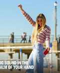 Woman holding Palm Sized Ultra Portable Waterproof And Drop Proof Bluetooth Speaker With Deep Bass, Ambient Edge Lighting outside