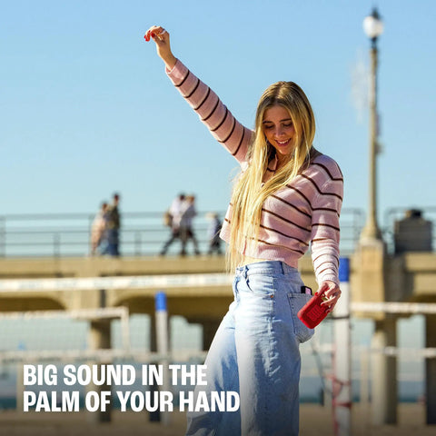 Woman holding Palm Sized Ultra Portable Waterproof And Drop Proof Bluetooth Speaker With Deep Bass, Ambient Edge Lighting outside