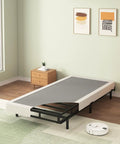 Twin Box Spring Low Profile Heavy Duty Platform Mattress Foundation on display in a minimalist room with light decor.