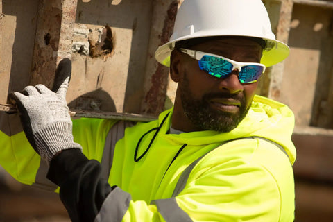 Worker wearing Ridgeline Full Brim Hard Hat With 4 Point Ratchet Fit Ultra Lightweight ABS Safety Helmet Ventilated White on site