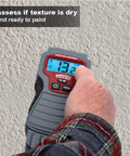 Hand using AccuMASTER Duo Pro Pin And Pinless Moisture Meter With Noninvasive Pad And Pin Sensors on wall surface