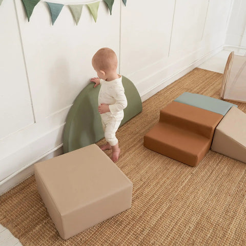 Toddler Tested Indoor Play Arena Featuring Super Soft Foam Climb Blocks Reconfigurable Crawl Tunnel Triangles And Steps Rock Solid Setup For Growing Little Legends, a child exploring soft foam blocks.