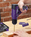 Person using 150 Piece Household Tool Set With 8V Cordless Drill Driver Kit For Home Maintenance DIY Projects And Repairs Complete Hand Tool Kit In Purple With Rust Resistant Tools And Handy LED Indicator Lights on wood