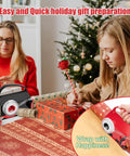 2 Pack Kickass Wrapping Paper Cutter And Tape Dispenser Set Delivers Rock Solid Straight Edges On Gift Wrap Every Time Includes Swappable Blades Zero Fuzz Ends Perfect For Holiday Present Wrangling Red And Black, used by two people for wrapping gifts.