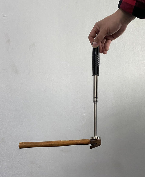Hand holding 41 Inch Magnetic Pickup Tool With 35 Pound Suction lifting hammer