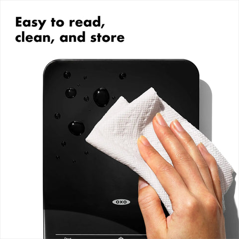 Person cleaning sleek black Precision Coffee Scale With Built In Timer For Pour Over, 6 Pound Capacity, durable surface