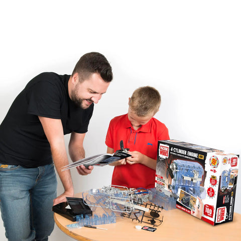 Father and son building the Build Your Own Visible Model Engine Kit With Four Cylinder Internal Combustion Mechanics, Realistic Sounds And Illumination, 100 Plus Pieces, STEM And Physics Based Replica Toy For Education And Hands On Fun on a table